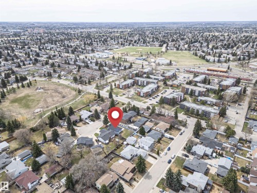 Aerial perspective of a suburban neighborhood featuring single-family homes with gray roofs and mature trees - 10412 39 Avenue, Edmonton, AB - Outdoor With View