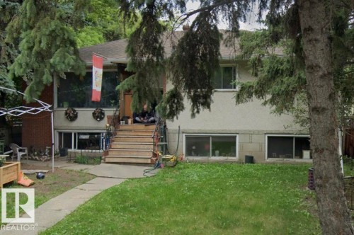 Split-level residence featuring a brick facade and stucco siding - 10450 69 Avenue, Edmonton, AB - Outdoor