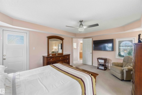This room features plush carpeting and a ceiling fan for comfort - #1 Colonial Close, Beaumont, AB - Indoor Photo Showing Bedroom