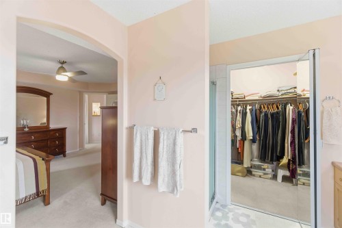 This property features an arched entryway, a ceiling fan, and a walk-in closet with ample storage - #1 Colonial Close, Beaumont, AB - Indoor