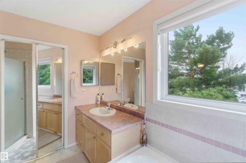 This bathroom features a vanity with a sink, a mirror, and overhead lighting - #1 Colonial Close, Beaumont, AB - Indoor Photo Showing Bathroom