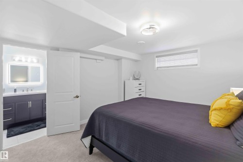 Bedroom with light-colored carpeting, a window with blinds, and a ceiling light fixture - #1 Colonial Close, Beaumont, AB - Indoor Photo Showing Bedroom