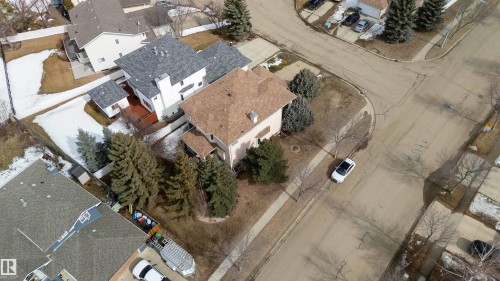 Aerial view of the property and surrounding neighborhood, featuring mature trees and paved roads - #1 Colonial Close, Beaumont, AB -  With View