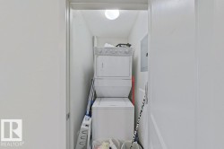 Dedicated laundry closet featuring a stacked washer and dryer - 