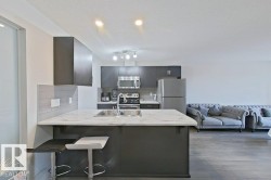 Kitchen island with a marbled countertop and undermount double sink - 