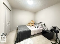 Spacious room featuring light-colored walls and carpeted flooring - 