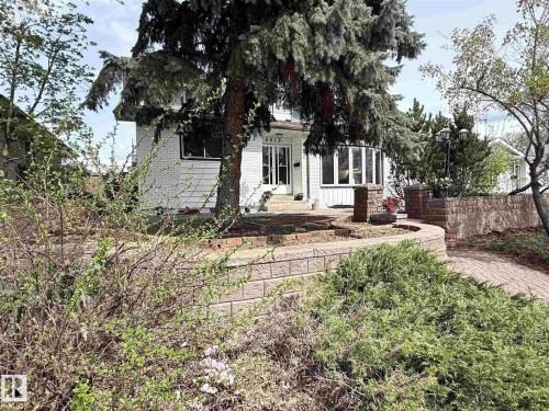 White-painted brick exterior featuring a prominent bay window - 8812 135 Avenue, Edmonton, AB - Outdoor