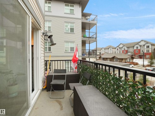 This property features a balcony with a concrete floor and a black metal railing - 64 655 Watt Boulevard, Edmonton, AB - Outdoor With Exterior