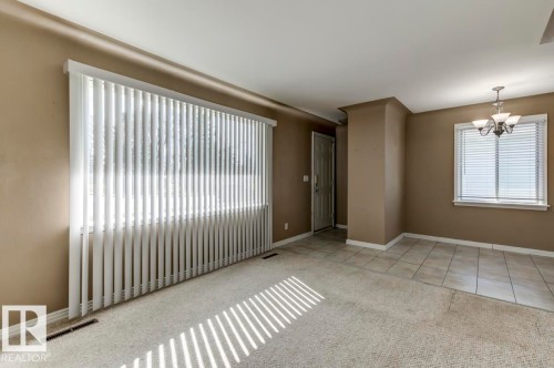 Living area with neutral wall tones and textured carpet - 9602 90 Street, Edmonton, AB - Indoor Photo Showing Other Room