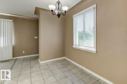 Interior space featuring light neutral wall tones and a decorative chandelier - 9602 90 Street, Edmonton, AB - Indoor Photo Showing Other Room