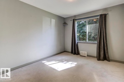 Carpeted room with a double-pane window, wall-to-wall carpeting, and neutral wall tones - 9602 90 Street, Edmonton, AB - Indoor Photo Showing Other Room