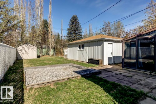 Expansive backyard with a detached storage shed, a structured sunroom, and a separate utility building - 9602 90 Street, Edmonton, AB - Outdoor
