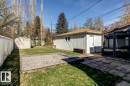 Expansive backyard with a detached storage shed, a structured sunroom, and a separate utility building - 9602 90 Street, Edmonton, AB  - Outdoor 