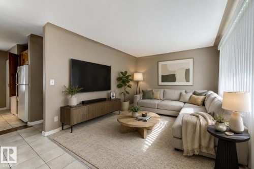 Expansive living area featuring light-toned walls, recessed lighting, and large windows with vertical blinds - 9602 90 Street, Edmonton, AB - Indoor Photo Showing Living Room