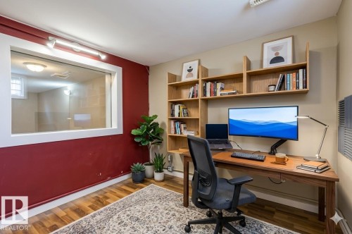 Built-in natural wood shelving provides substantial storage - 9602 90 Street, Edmonton, AB - Indoor Photo Showing Office