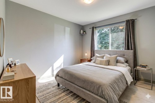 Light gray walls with a framed window, overhead flush-mount lighting, and light-toned flooring - 9602 90 Street, Edmonton, AB - Indoor Photo Showing Bedroom