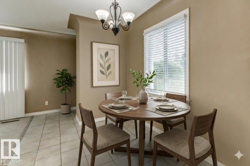 Dining area featuring a circular wood-finish table, a decorative chandelier, white window blinds, and light-toned tile flooring - 9602 90 Street, Edmonton, AB - Indoor Photo Showing Dining Room
