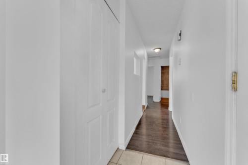 Hallway featuring white walls, wood-finish flooring, and a flush-mount ceiling light fixture - 3520 19 Avenue, Edmonton, AB - Indoor Photo Showing Other Room