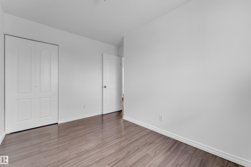 Room featuring wood-finish flooring, crisp white walls, and white trim - 3520 19 Avenue, Edmonton, AB - Indoor Photo Showing Other Room