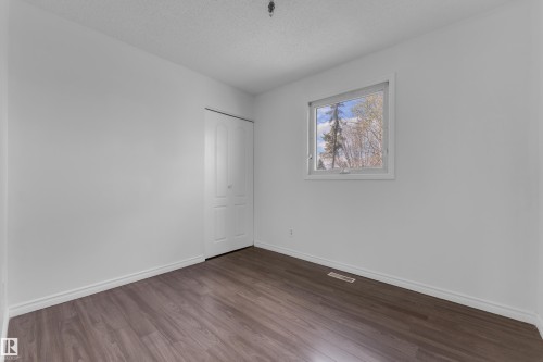 Interior space featuring wood-finish flooring, white baseboards, and a white ceiling - 3520 19 Avenue, Edmonton, AB - Indoor Photo Showing Other Room