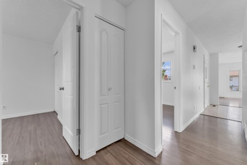 White interior walls with wood-finish flooring - 3520 19 Avenue, Edmonton, AB - Indoor Photo Showing Other Room