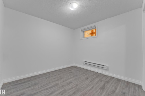 Room featuring wood-finish flooring, white baseboards, and a neutral wall palette - 3520 19 Avenue, Edmonton, AB - Indoor Photo Showing Other Room