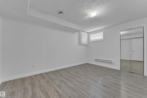 Room featuring wood-finish flooring, white baseboards, and a white ceiling - 3520 19 Avenue, Edmonton, AB - Indoor Photo Showing Other Room