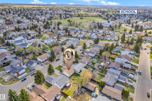 Aerial view of a residential neighborhood with numerous single-family homes, mature trees, and a visible green space - 3520 19 Avenue, Edmonton, AB - Outdoor With View