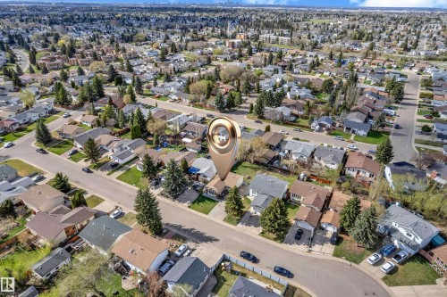Aerial perspective showcasing a residential neighborhood with numerous single-family homes, mature trees, and paved streets - 3520 19 Avenue, Edmonton, AB - Outdoor With View