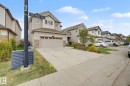 Two-story residence featuring light-toned siding and stone veneer accents - 6016 10 Avenue, Edmonton, AB  - Outdoor With Facade 