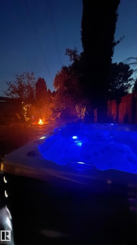 Outdoor spa with blue lighting - 515 Lakeshore Drive, Cold Lake, AB - Outdoor
