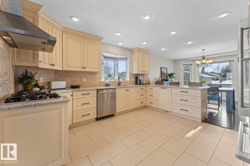 The kitchen features light-toned cabinetry, granite countertops, and stainless steel appliances - 515 Lakeshore Drive, Cold Lake, AB - Indoor Photo Showing Kitchen With Upgraded Kitchen