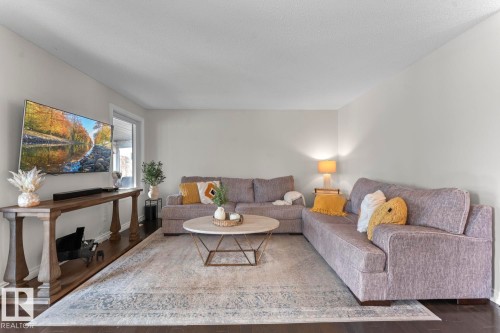 Living room featuring dark hardwood floors, light-colored walls, and a large window - 515 Lakeshore Drive, Cold Lake, AB - Indoor Photo Showing Living Room