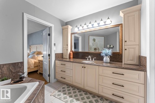 The bathroom features a spacious vanity with an integrated sink, a large mirror, and ample cabinetry for storage - 515 Lakeshore Drive, Cold Lake, AB - Indoor Photo Showing Bathroom