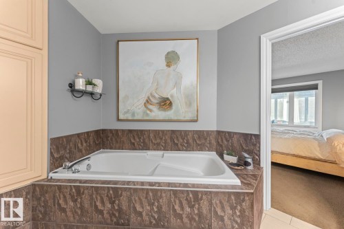 The bathroom features a built-in tub with a tiled surround - 515 Lakeshore Drive, Cold Lake, AB - Indoor Photo Showing Bathroom