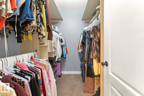The property includes a walk-in closet with carpeted flooring, built-in shelving, and hanging rods - 515 Lakeshore Drive, Cold Lake, AB - Indoor With Storage