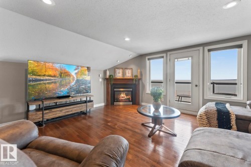 Living area featuring hardwood floors, a fireplace with a mantel, and recessed lighting - 515 Lakeshore Drive, Cold Lake, AB - Indoor Photo Showing Living Room With Fireplace