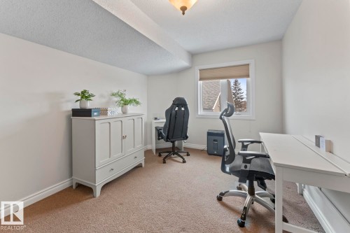 This room features light-colored walls and carpeting, a window with a roller blind, and an overhead light fixture - 515 Lakeshore Drive, Cold Lake, AB - Indoor Photo Showing Office