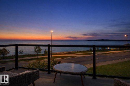 Enjoy stunning water views from the private balcony, featuring a glass railing and a paved surface - 515 Lakeshore Drive, Cold Lake, AB - Outdoor With Body Of Water With View