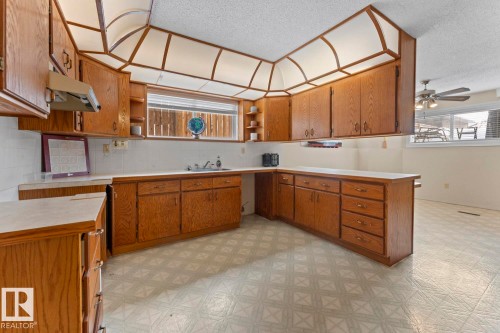 Kitchen featuring wooden cabinetry, light-colored countertops, and patterned floor tiling - 515 Lakeshore Drive, Cold Lake, AB - Indoor Photo Showing Kitchen