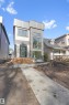 Modern exterior featuring a prominent stone facade, large black-framed windows, and horizontal wood-plank steps - 7936 91 Avenue, Edmonton, AB  - Outdoor 