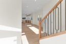 Light-toned wood-finish flooring extends throughout, complemented by recessed lighting - 7936 91 Avenue, Edmonton, AB  - Indoor Photo Showing Other Room 