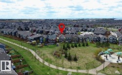Residential neighborhood featuring a paved walking path, green spaces, and community recreation areas - 