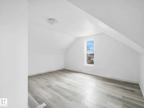 Room with light wood-finish flooring, white walls, and a single window - 4322 53 Street, Wetaskiwin, AB - Indoor Photo Showing Other Room