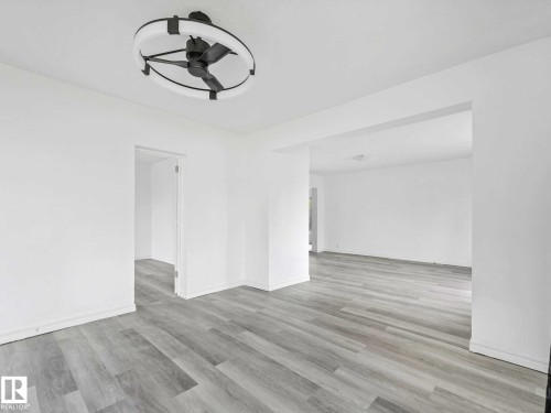Bright interior featuring light wood-finish flooring - 4322 53 Street, Wetaskiwin, AB - Indoor Photo Showing Other Room