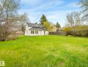 Expansive grassy yard with mature trees - 4322 53 Street, Wetaskiwin, AB  - Outdoor 