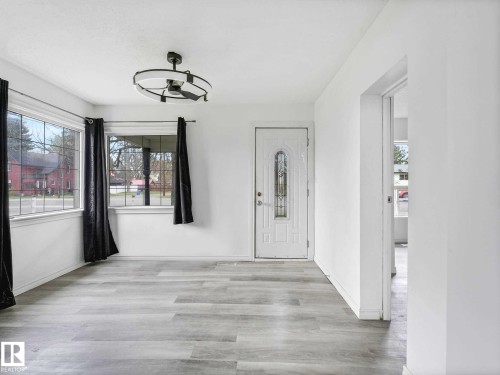Entry area featuring light wood-finish flooring, white walls, and a decorative ceiling fan - 4322 53 Street, Wetaskiwin, AB - Indoor Photo Showing Other Room
