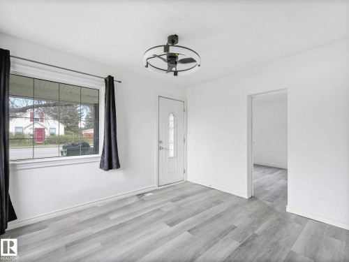 Entry area featuring light wood-finish flooring, white walls, and a contemporary ceiling fan with integrated lighting - 4322 53 Street, Wetaskiwin, AB - Indoor Photo Showing Other Room