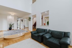 Spacious multi-level interior featuring high ceilings, wood-finish flooring, and recessed lighting - 