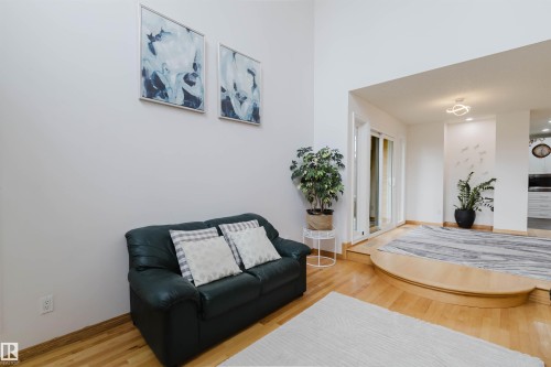 Interior space featuring light wood-finish flooring, high ceilings, and a raised platform with contrasting flooring - 342 O'Connor Close, Edmonton, AB - Indoor Photo Showing Living Room